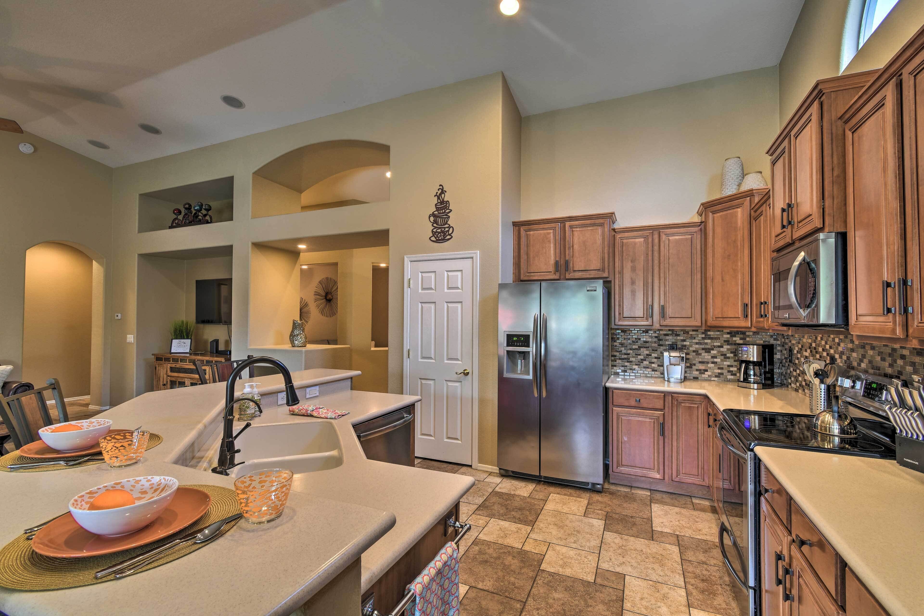 A modern kitchen with a stainless steel refrigerator, wooden cabinets, and a built-in oven.