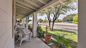 A covered porch with wicker furniture and potted plants. - Central Phoenix Home < 3 Mi to Downtown! (Phoenix)