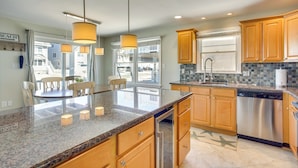 A modern kitchen with granite countertops, wooden cabinets, and stainless steel appliances. - Avalon Vacation Rental w/ Porch & Grill! (Avalon)