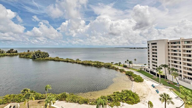 A coastal hotel with a view of the sea, a sandy beach, and a clear sky. - Private Beach Access: Hudson Resort Condo! (Hudson)