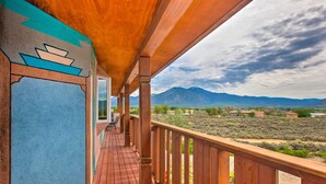 A wooden deck with a view of mountains and sparse vegetation. - Taos Area Escape on 1.5 Acres: Panoramic Mtn Views (El Prado)