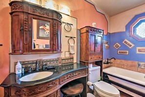 A bathroom with a wooden vanity, a sink, and a bathtub. - Taos Area Escape on 1.5 Acres: Panoramic Mtn Views (El Prado)