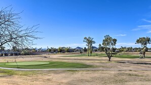 A golf course with a clear sky, green fairways, and trees. - Scottsdale Condo w/ Pool Access: Hike, Swim & Shop (Scottsdale)