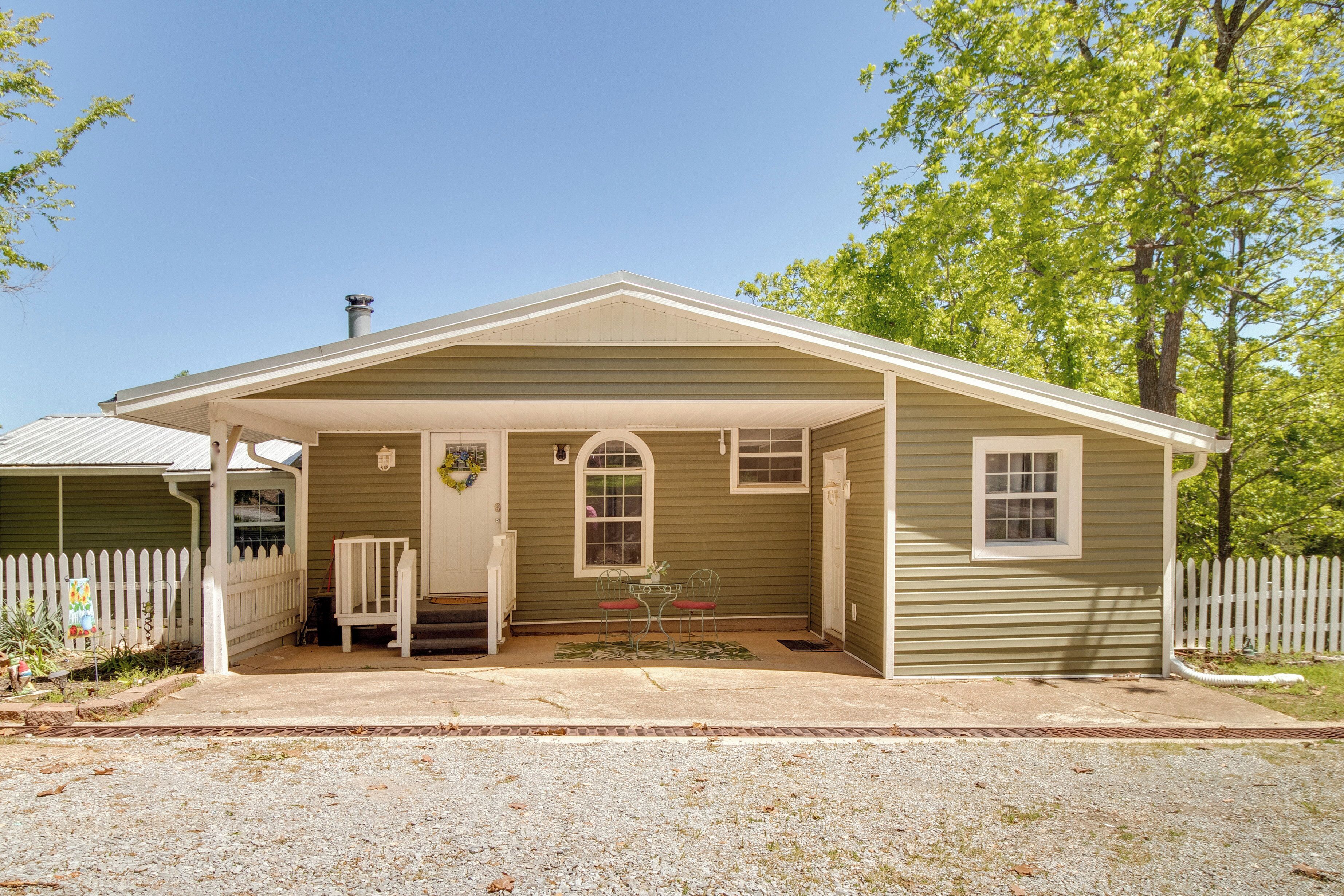 A single-story house with a covered porch, a front door, and a small front yard.