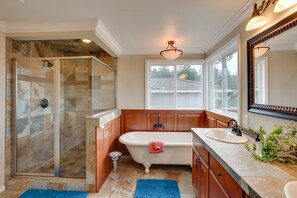 A bathroom with a glass-enclosed shower, a freestanding bathtub, a sink, and a large mirror. - Washington Vacation Rental w/ Hot Tub Near Tacoma (University Place)