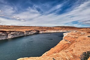 A natural landscape with a river, cliffs, and a clear sky. - Walk to Rim View Trail: Page Home w/ Deck & Yard (Page)