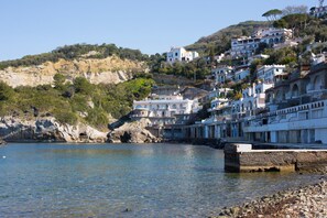 A coastal town with buildings built on a hillside overlooking the sea.