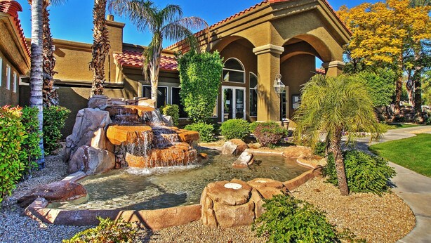A building with a courtyard featuring a waterfall, palm trees, and a well-maintained garden. - Near Bellair Golf Club! Phoenix Abode w/ Pool (Phoenix)