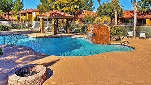 A swimming pool with a fire pit, lounge chairs, and a covered seating area. - Near Bellair Golf Club! Phoenix Abode w/ Pool (Phoenix)