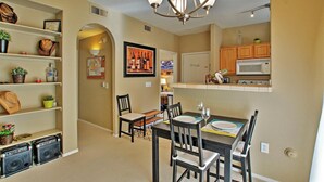 A dining area with a table, chairs, and a chandelier. There is a kitchen area with a microwave and cabinets. - Near Bellair Golf Club! Phoenix Abode w/ Pool (Phoenix)