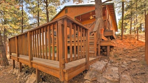 A wooden deck with a railing, a staircase leading to a cabin, and a rocky ground. - Rustic Cabin w/ Deck ~ 4 Mi to Old Town Flagstaff! (Flagstaff)