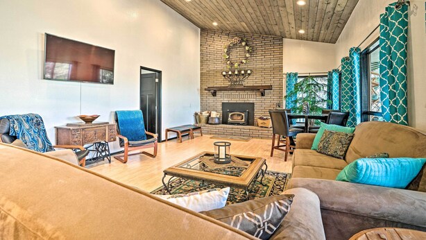 A spacious living room with a fireplace, comfortable seating, and a view of the outdoors.