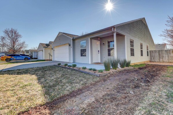 A single-story house with a garage, a front porch, and a small front yard with landscaping.