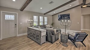 A spacious living area with a sectional sofa, a coffee table, and a floor lamp. - Canal-front Cape Coral Home: Pool & Patio (Cape Coral)