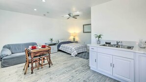 A compact bedroom with a bed, bedside table, and a small table with chairs. - Cozy Lompoc Studio w/ Patio ~ 9 Mi to Beach (Lompoc)