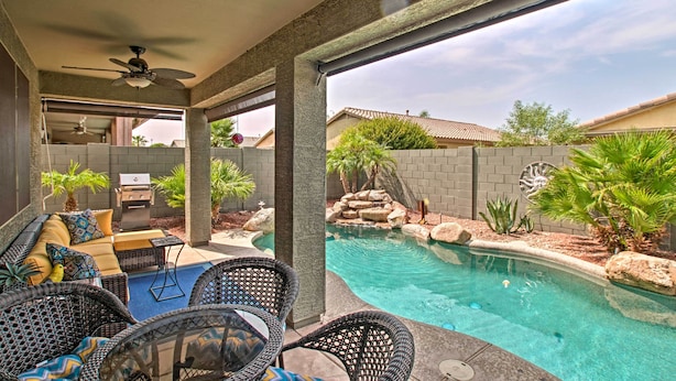 A covered outdoor area with a pool, seating, and a grill. - Game Room, Fenced Yard: Estrella Oasis in Goodyear (Goodyear)