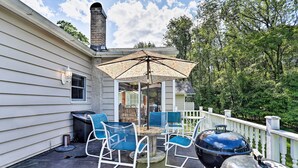 A patio with outdoor furniture, a grill, and a decorative umbrella. - Wawayanda House on 62 Acres - Multiple Fireplaces! (Middletown)