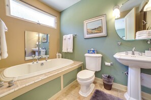 A bathroom with a bathtub, toilet, sink, and mirrors. - Chic California Escape w/ Pool, Hot Tub & Patio! (Salinas)