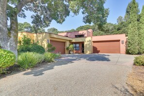 A two-story house with a driveway leading to a garage. - Chic California Escape w/ Pool, Hot Tub & Patio! (Salinas)
