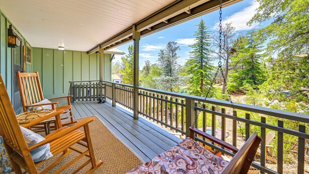 A wooden deck with a railing, a rocking chair, and a bench. - Bike, Hike & Unwind: Tranquil Payson Getaway! (Payson)