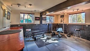 A gym with a bench press, dumbbells, and a squat rack. - Bike, Hike & Unwind: Tranquil Payson Getaway! (Payson)