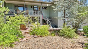 A two-story building with a balcony, a flag, and a staircase leading to the upper floor. - Bike, Hike & Unwind: Tranquil Payson Getaway! (Payson)