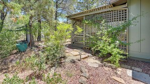 A garden area with a wooden fence, a stone pathway, and various shrubs. - Bike, Hike & Unwind: Tranquil Payson Getaway! (Payson)