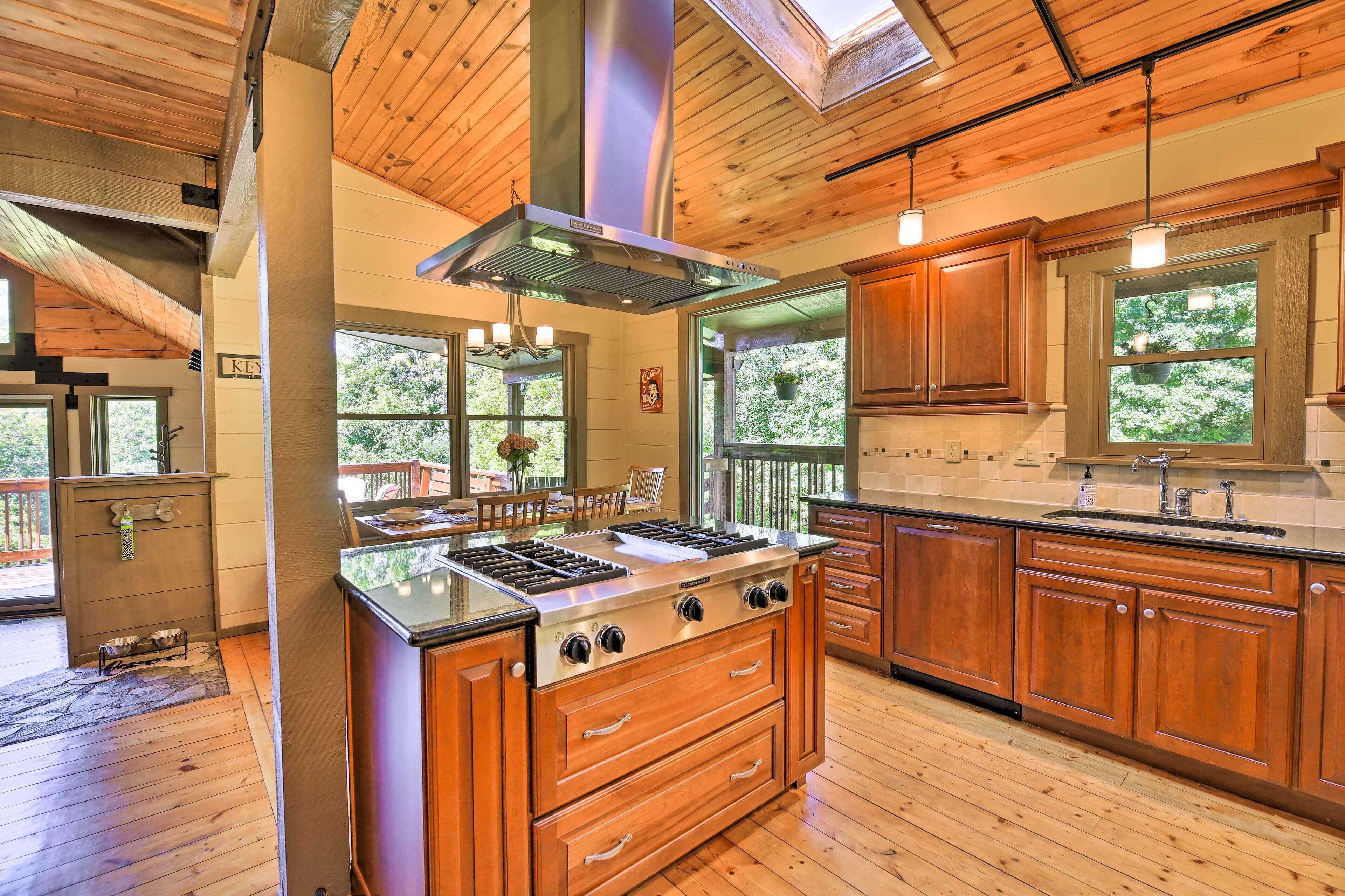 A spacious kitchen with wooden cabinets, a large stove, and a skylight.