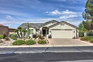 A single-story house with a garage, surrounded by a desert garden with cacti and small shrubs. - AZ Home w/ Resort-style Amenities & Mtn View! (Saddlebrooke)