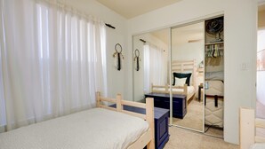 A bedroom with a bed, a dresser, a mirror, and a closet with hanging clothes. - Scottsdale Home: Pool Access, 13 Mi to Phoenix (Scottsdale)