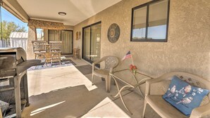 A patio area with a barbecue grill, outdoor furniture, and a view of the backyard. - Lake Havasu City Home w/ Views: 3 Mi to Marina! (Lake Havasu City)