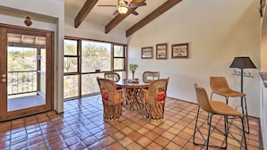 A dining area with a round table, four wicker chairs, and a ceiling fan. - Beautiful 'saguaro Vista' w/ Mountain Views! (Tucson)