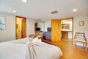 A bedroom with a bed, wooden furniture, a desk, and a chair. - On the Ocean Private Next to Nature Preserve (Indialantic)