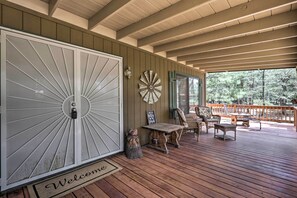 A wooden deck with a welcome mat, a bench, and outdoor furniture. - 'hilda's Cabin' Mtn-view Retreat in Pine! (Pine)