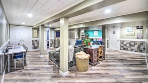A spacious living area with a dining table, sofa, and a large window. - Mammoth Cave Rental on 50 Acres: Shared Amenities (Mammoth Cave)