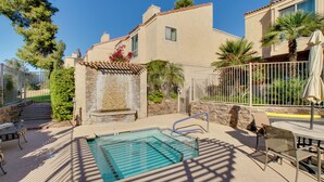 A swimming pool with a stone wall and steps leading up to a house. - First-floor Condo w/ Golf Course Views & Pool! (Scottsdale)