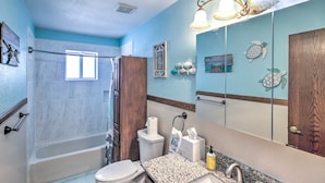 A bathroom with a bathtub, toilet, sink, and a large mirror. - 4 Mi to Lake Havasu: Luxe Home w/ Outdoor Oasis (Lake Havasu City)