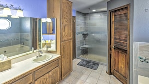 A bathroom with a large mirror, wooden vanity, and a shower area with a glass door. - 4 Mi to Lake Havasu: Luxe Home w/ Outdoor Oasis (Lake Havasu City)