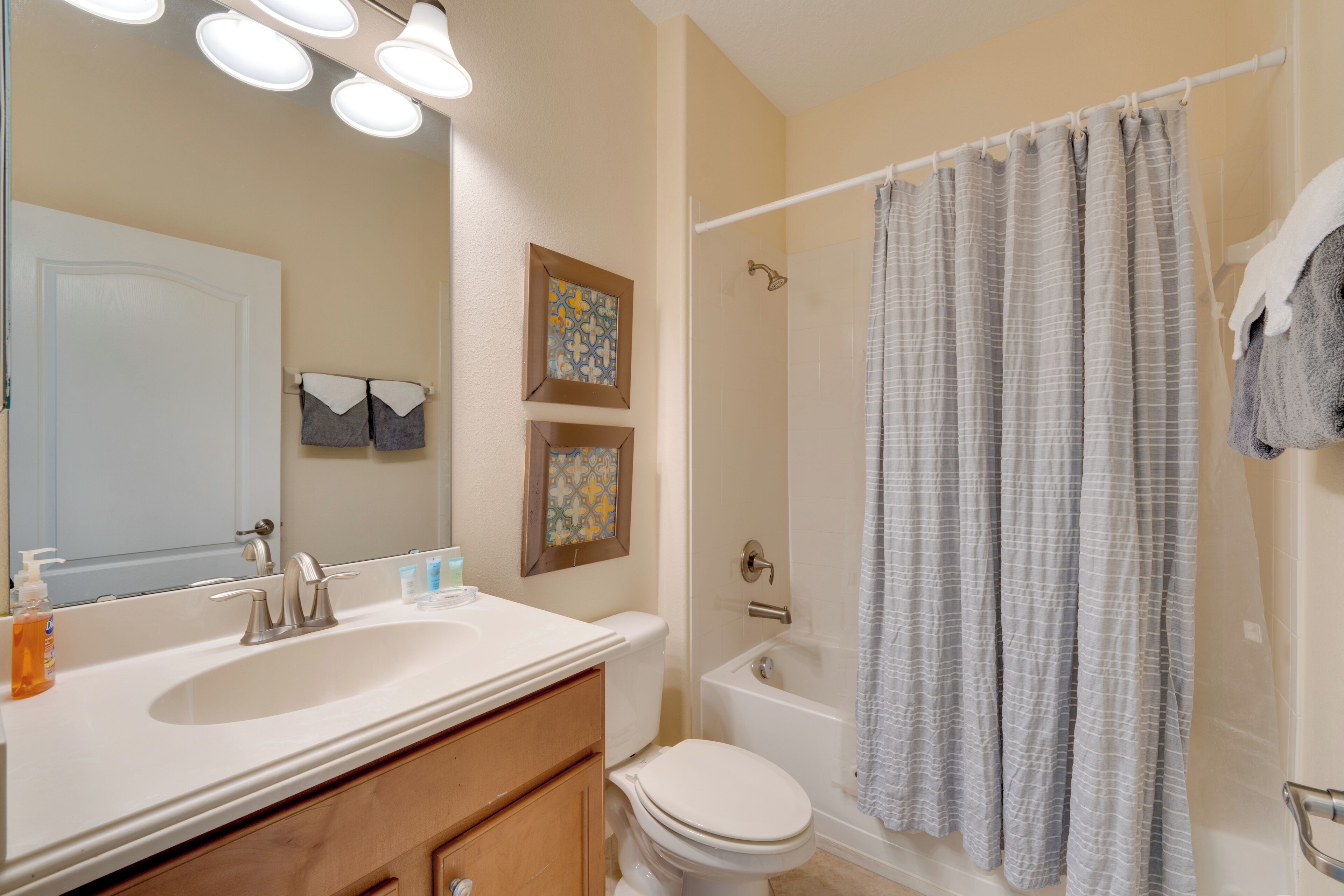 A bathroom with a sink, toilet, and bathtub.
