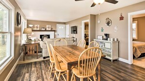 A dining area with a wooden table and chairs, a ceiling fan, and a kitchen in the background. - Pine River Lake Home w/ Boat & Kayak Rentals! (Pine River)