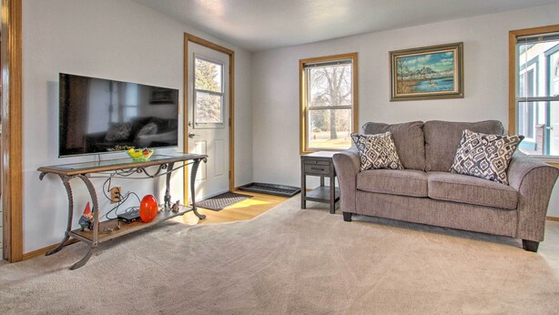 A living room with a television, sofa, and two windows. - Pet-friendly Malta Home Near Hunting Areas! (Malta)