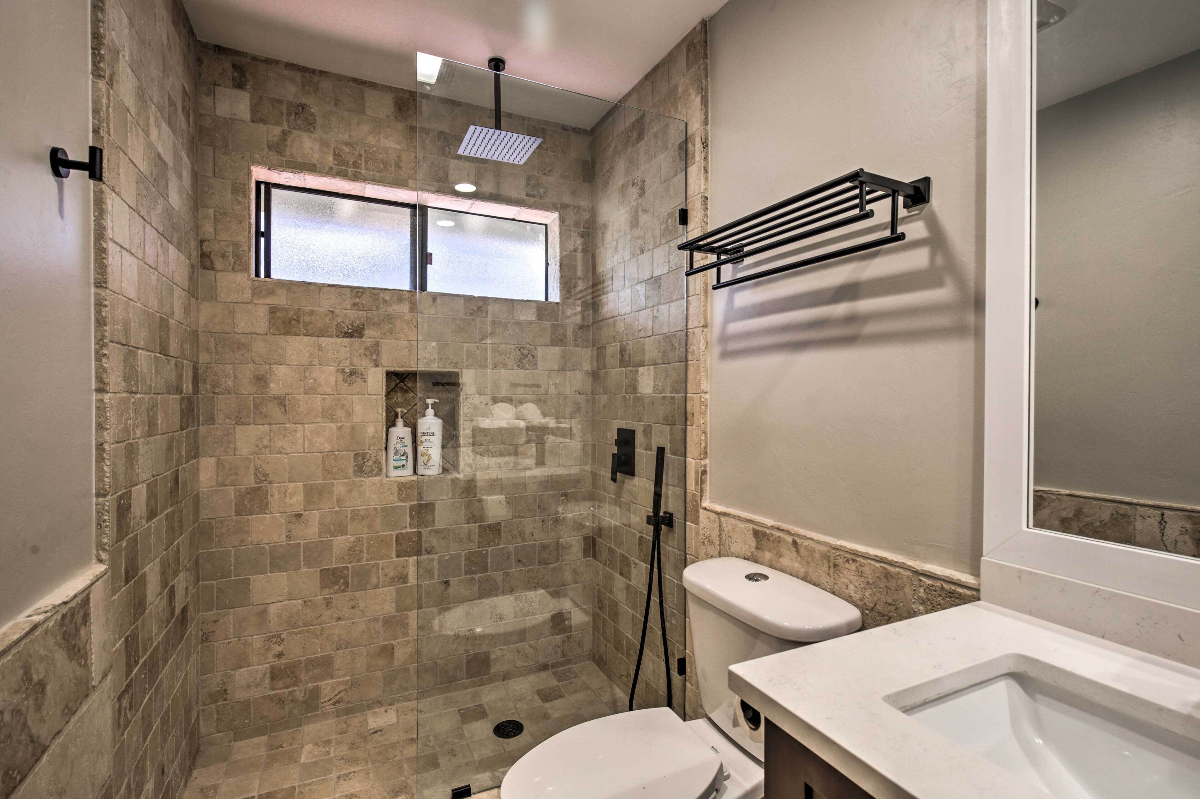Un baño con ducha, inodoro y lavabo.