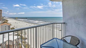 A balcony with a view of a beach and ocean. - Steps to Shore: Beachfront Studio w/ Pool Access! (Myrtle Beach)