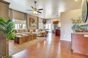 A spacious living room with a sofa, coffee table, and a ceiling fan. - Private Patio + Gazebo: Show Low Hideaway! (Show Low)