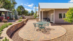 A patio with a circular brick pattern, a glass table with chairs, and a covered seating area. - Private Patio + Gazebo: Show Low Hideaway! (Show Low)