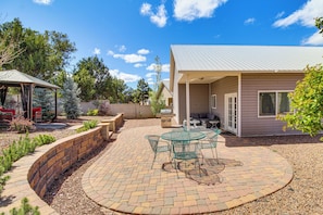 A patio with a circular brick pattern, a glass table with chairs, and a covered seating area. - Private Patio + Gazebo: Show Low Hideaway! (Show Low)