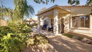 A house with a covered patio, outdoor seating, and a gravel driveway. - 55+ Gilbert Home w/ Yard, Golf Course On-site (Gilbert)