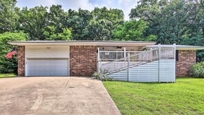 A two-story house with a garage, a covered porch, and a staircase leading to the upper level. - Views! Lake Home w/ 2 Decks, Boat Parking & Peace (Garfield)