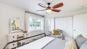 A bedroom with a bed, a dresser, a chair, a ceiling fan, and a window. - Views! Lake Home w/ 2 Decks, Boat Parking & Peace (Garfield)