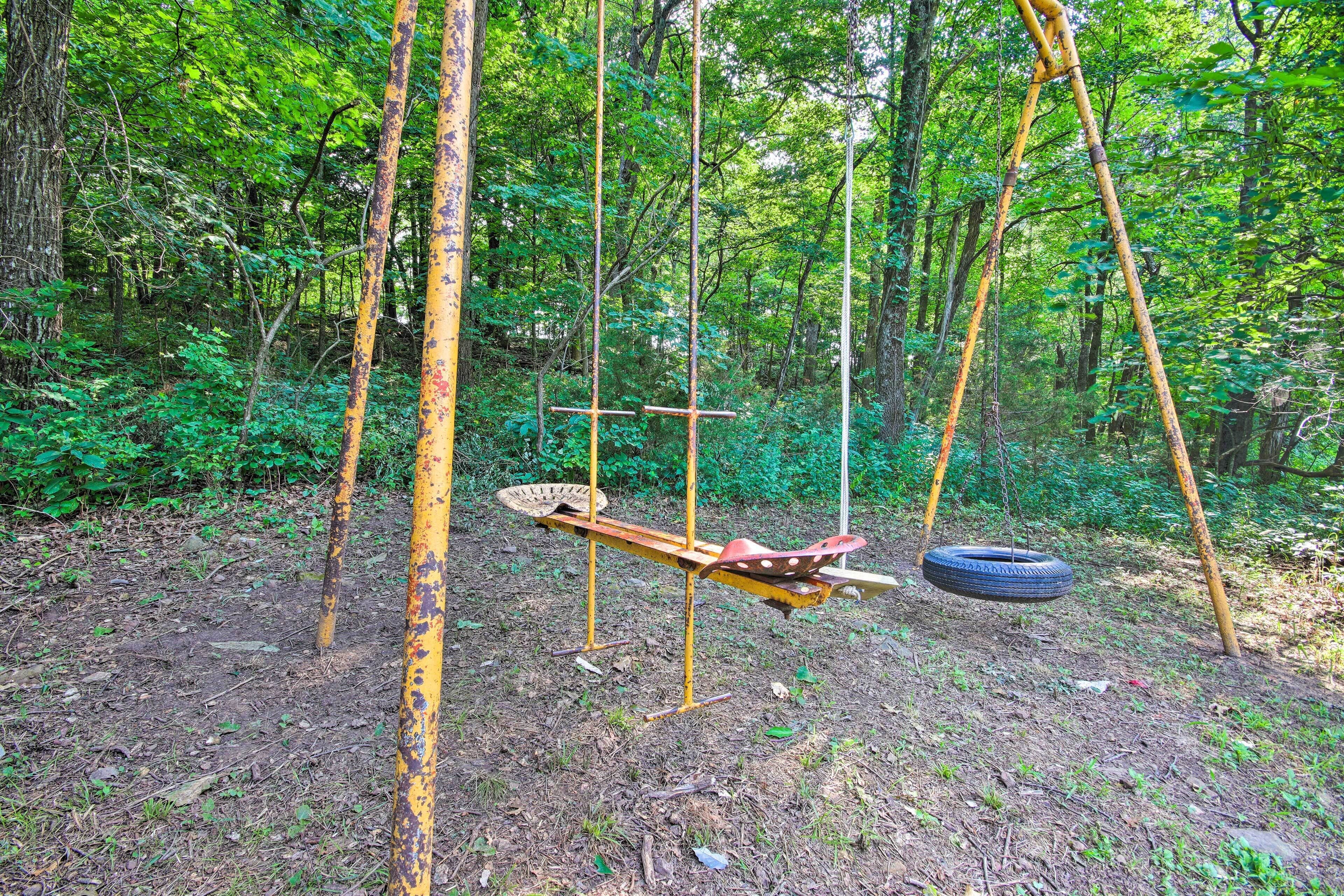 Un conjunto de columpios de madera rústica en un área boscosa.